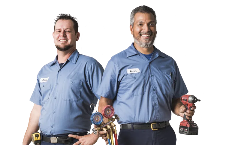 HVAC technicians with refrigerant gauges and a drill